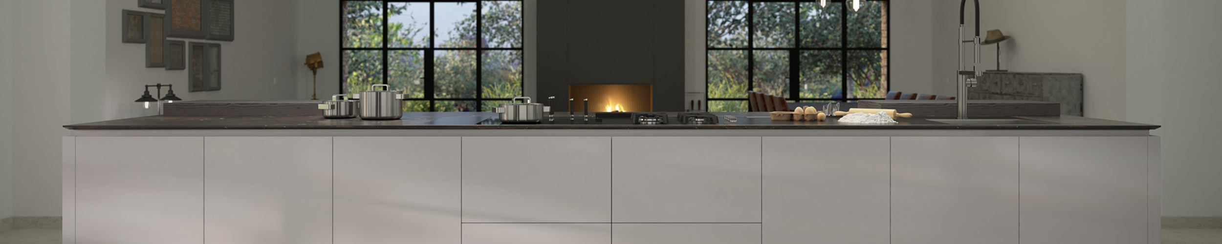 Vista frontal de isla de cocina con encimera de color negro y muebles de color gris claro con sistema LÓGICA de Senssia con fregadero y hornillos de cocinado